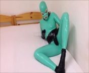 Jade and black rubber doll in total latex enclosure from total doll